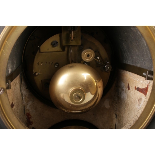 35 - A late 19th century black slate mantel clock with barometer, featuring a visible escapement within a... 