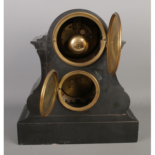 35 - A late 19th century black slate mantel clock with barometer, featuring a visible escapement within a... 