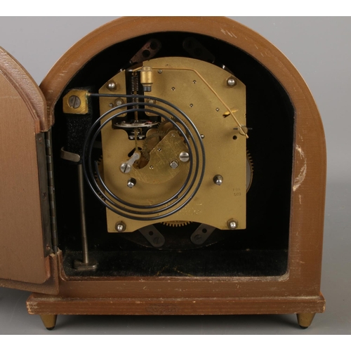 37 - A circa 1950's Smiths 8 day floating balance mantel clock with dome top and baton markers.