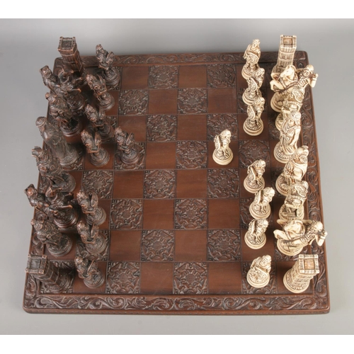 45 - A complete composite chess set with a Tudor Rose carved board, board size 46 x 46cm.