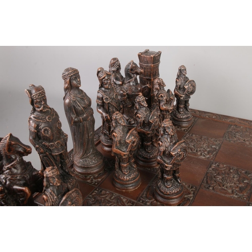 45 - A complete composite chess set with a Tudor Rose carved board, board size 46 x 46cm.