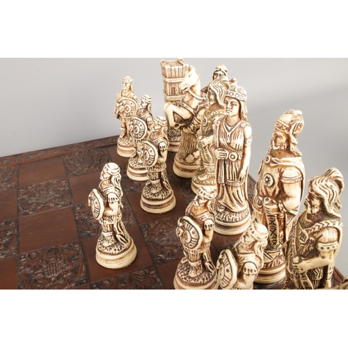 45 - A complete composite chess set with a Tudor Rose carved board, board size 46 x 46cm.