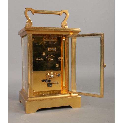 3 - A brass Angelus carriage clock, with key. Featuring open top escapement, 11 jewel movement and Roman... 