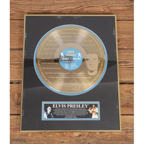 A Framed Elvis Presley Number One Hits limited edition gold disc. 180/ ...