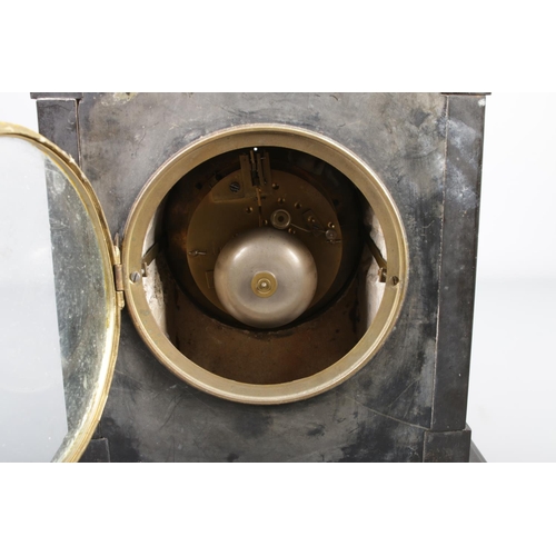 8 - A Victorian black slate mantel clock with a black ornate chapter ring with gilded Roman numeral mark... 