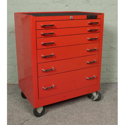 A red metal MATCO tool storage box/work bench on wheels with six ...