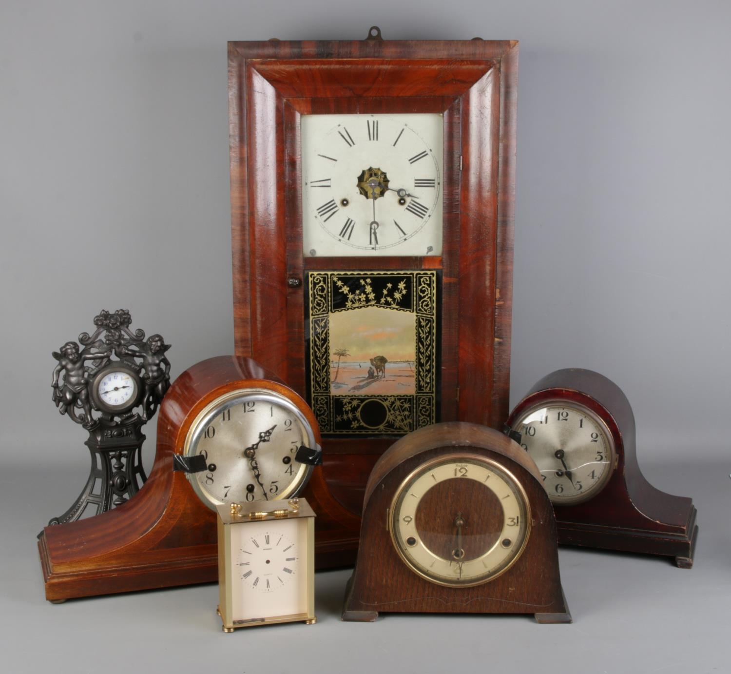 A collection of clocks; to include an Enfield napoleon hat inlaid ...