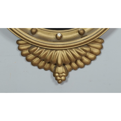 219 - An antique Regency style giltwood convex wall mirror. With carved eagle and ball frieze. Length 91cm... 