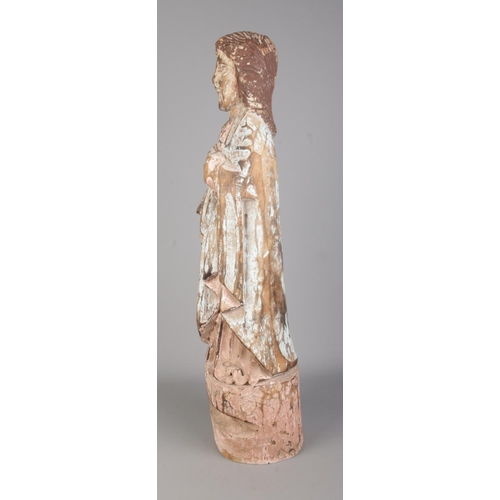 121 - A South American Spanish colonial carved wooden Santos statue. Height 65cm.