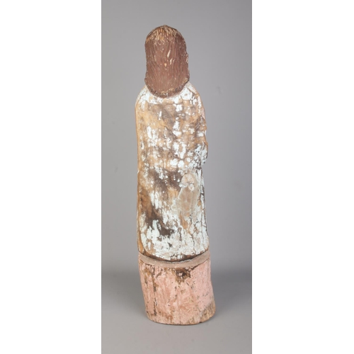 121 - A South American Spanish colonial carved wooden Santos statue. Height 65cm.