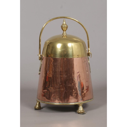 122 - A Dutch 19th century copper and brass doofpot/ash bucket. With swing handle and raised on thee suppo... 