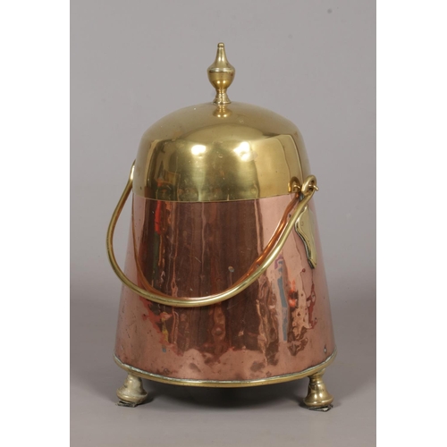 122 - A Dutch 19th century copper and brass doofpot/ash bucket. With swing handle and raised on thee suppo... 
