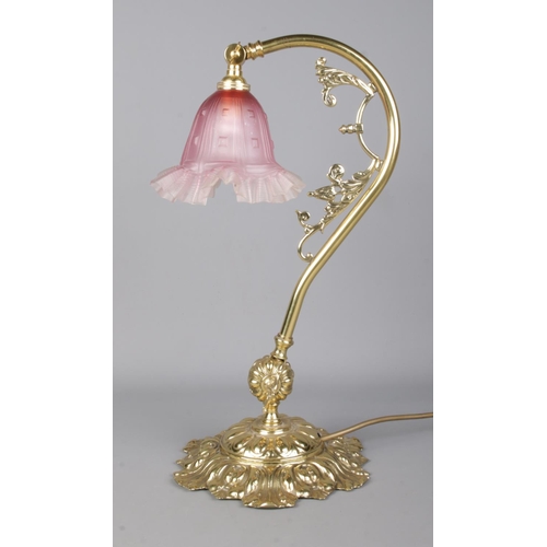 125 - An Art Nouveau style brass adjustable lamp with frilled glass shade. Height 43cm.