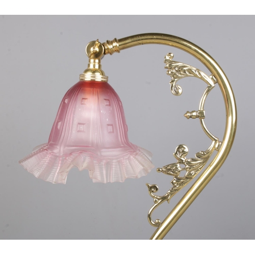 125 - An Art Nouveau style brass adjustable lamp with frilled glass shade. Height 43cm.