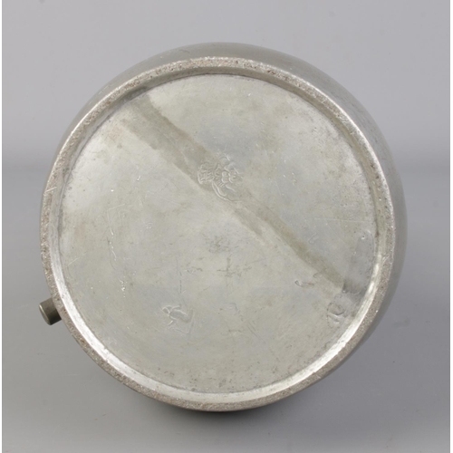 129 - An antique pewter tankard. With scrolled handle and hinged lid. Touch marks to base. Height 26cm.