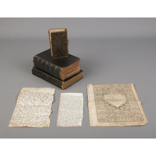 136 - Three 19th century leather bound bibles, along with a page from The New Testament, 1613.