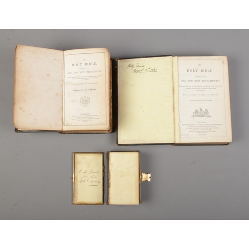 136 - Three 19th century leather bound bibles, along with a page from The New Testament, 1613.