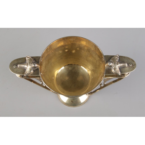 143 - An Edwardian Arts & Crafts silver gilt twin handled cup, modelled on Nestor's Cup from Mycenae. With... 