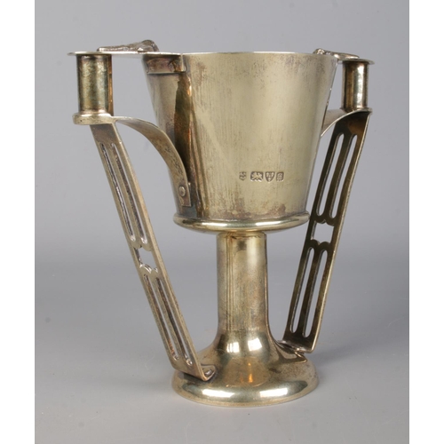 143 - An Edwardian Arts & Crafts silver gilt twin handled cup, modelled on Nestor's Cup from Mycenae. With... 