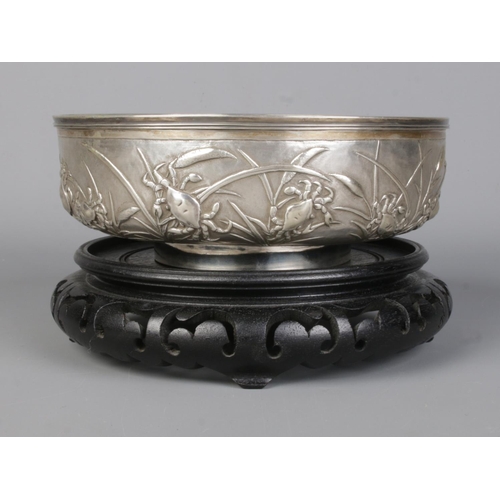 146 - A late 19th/early 20th century Chinese silver bowl with embossed decoration depicting crabs and rice... 