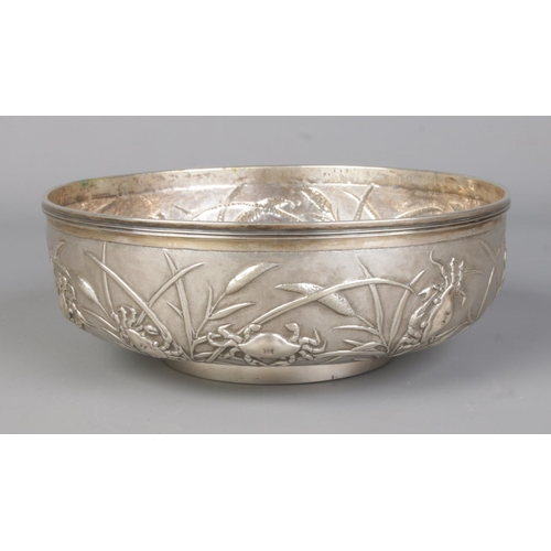 146 - A late 19th/early 20th century Chinese silver bowl with embossed decoration depicting crabs and rice... 