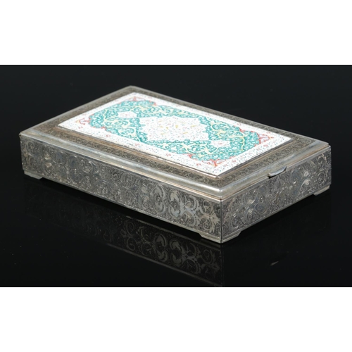 149 - A Persian silver box with extensive engraved decoration. The hinged lid with central enamelled panel... 