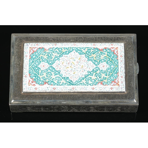 149 - A Persian silver box with extensive engraved decoration. The hinged lid with central enamelled panel... 