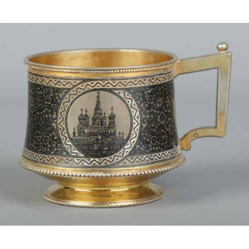 150 - A 19th century Russian silver gilt cup with niello decoration. With landscape scenes depicting the K... 