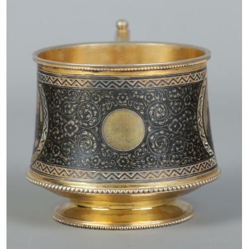 150 - A 19th century Russian silver gilt cup with niello decoration. With landscape scenes depicting the K... 