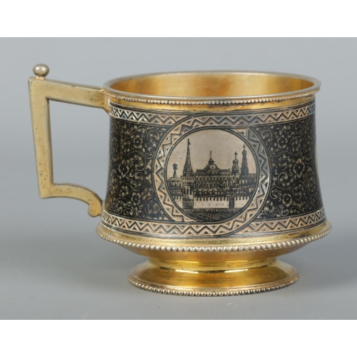 150 - A 19th century Russian silver gilt cup with niello decoration. With landscape scenes depicting the K... 