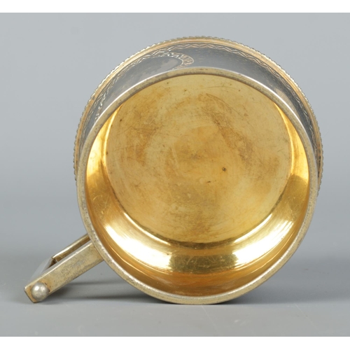 150 - A 19th century Russian silver gilt cup with niello decoration. With landscape scenes depicting the K... 