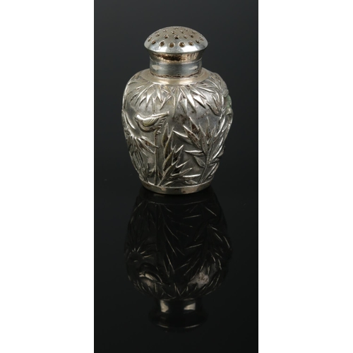 154 - A Chinese silver pepperette. Decorated with bamboo and birds. Retailed by Luen Wo, Shanghai. Height ... 
