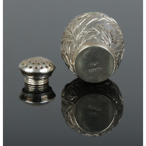 154 - A Chinese silver pepperette. Decorated with bamboo and birds. Retailed by Luen Wo, Shanghai. Height ... 