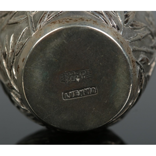 154 - A Chinese silver pepperette. Decorated with bamboo and birds. Retailed by Luen Wo, Shanghai. Height ... 