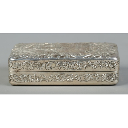 156 - An Edwardian silver box. With repousse decoration depicting a married couple departing in a horse dr... 
