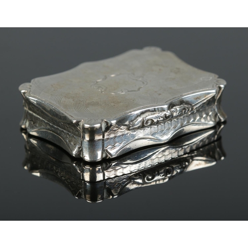 161 - A Victorian silver vinaigrette. With engraved decoration to outer case and gilt foliate grill to int... 