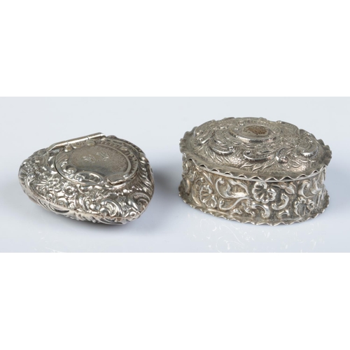 163 - Two silver pill boxes with repousse decoration. Heart shaped example assayed Birmingham 1898 by Jose... 