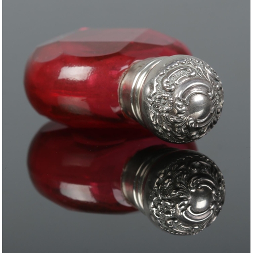 166 - An Edwardian faceted ruby glass scent bottle with silver top. Assayed Birmingham 1905. 6cm.