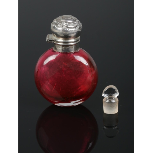 166 - An Edwardian faceted ruby glass scent bottle with silver top. Assayed Birmingham 1905. 6cm.