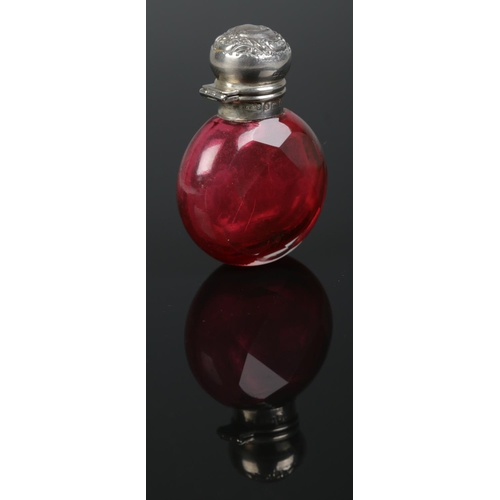 166 - An Edwardian faceted ruby glass scent bottle with silver top. Assayed Birmingham 1905. 6cm.