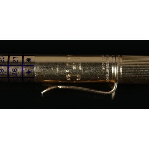 170 - An 18ct gold propelling pencil by Goldsmiths & Silversmiths Company Ltd, with enamelled rotating cal... 
