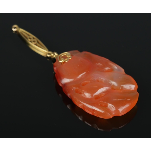 175 - An 18ct gold mounted carved jade pendant. Drop length 5cm.