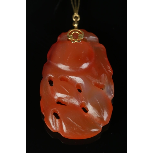 175 - An 18ct gold mounted carved jade pendant. Drop length 5cm.