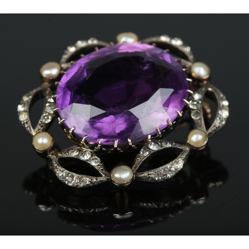 177 - A Victorian 9ct gold Amethyst, seed pearl and paste brooch. Amethyst 1.7cm x 2cm. 8.2g.