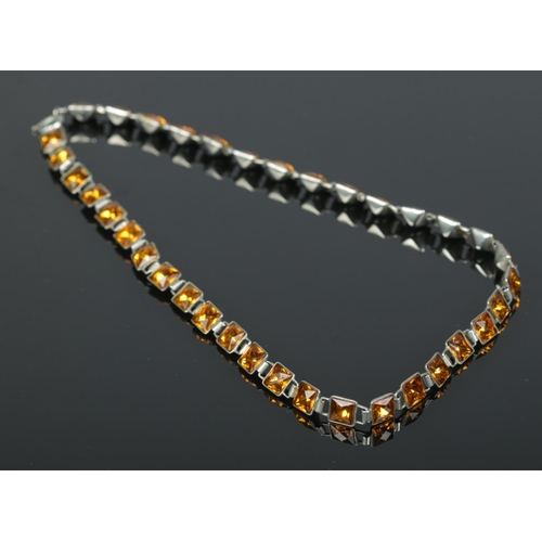 179 - An antique white metal necklace set with yellow paste. Length 14 inches.