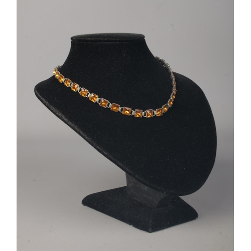 179 - An antique white metal necklace set with yellow paste. Length 14 inches.