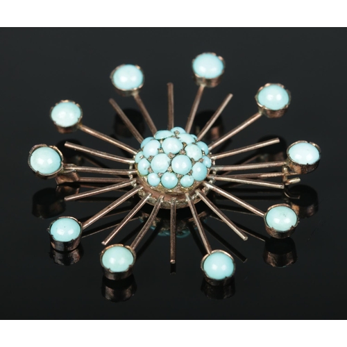 180 - A yellow metal turquoise set starburst brooch. 5.3cm x 5.3cm. 7.83g.