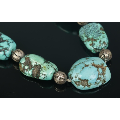 185 - A white metal and turquoise matrix bead necklace. Length 21 inches.