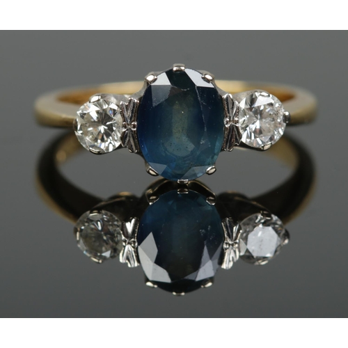 187 - An 18ct gold sapphire and diamond three stone ring. Each diamond approximately 0.25ct, the central s... 
