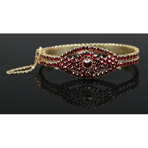 210 - A vintage Bohemian Biedermeier garnet hinged bangle. Stamped 800 to clasp. Interior measurements 6.5... 